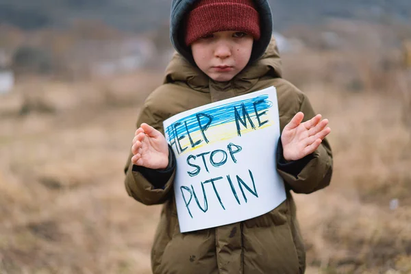 War of Russia against Ukraine. Crying boy asks to stop the war in Ukraine. Stock Image