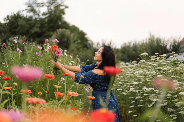 A Young woman prune flowers in a floristic flower farm. Woman florist. — Stock Photo, Image