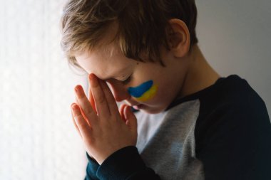 Ukraynalı çocuk gözlerini kapadı ve Ukrayna 'daki savaşı durdurmak için dua etti..