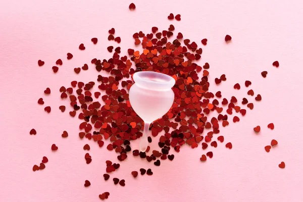 Silicone menstrual cup. Womens health and alternative hygiene. Cup with little red hearts — Foto de Stock