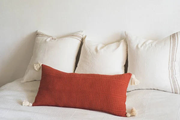 Linen pillows on a white bed. Comfortable bed with pillows in room. Modern home decor. Interior design. Template.