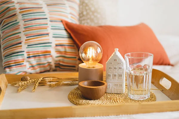 Linen pillows on a white bed with home decor. Still life details in home on a bed. Cozy home. Sweet home