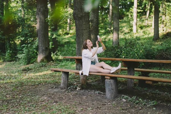 Funny young woman laughs and talking by video call on the phone. The concept of lifestyle mobility and modern wireless communication technologies