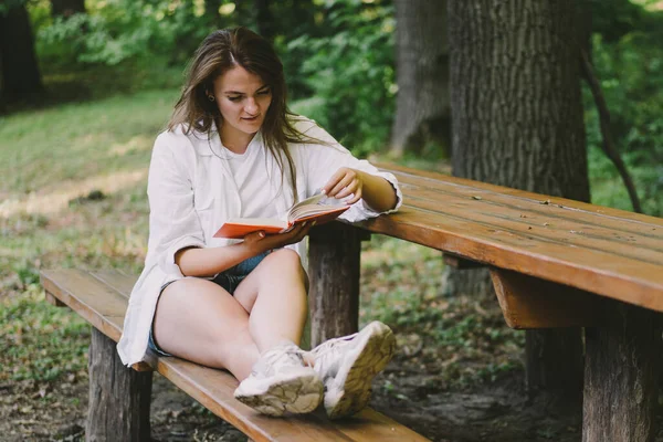 Woman Holds Book Her Hands Reading Book Sitting Bench Outdoors — Foto de Stock