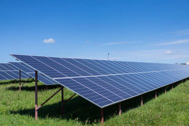 Solar batteries power station located in a field. Renewable energy clean and good environment.
