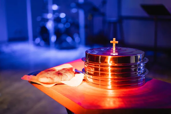 The process of breaking bread in the modern church. Breaking bread ceremony in protestant church. Religious tradition of breaking bread. Bread and wine.