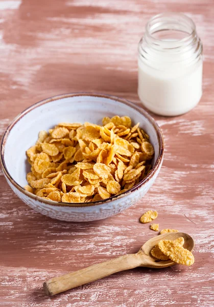 Cereal, a spoon and a pot of milk — Stock Photo, Image