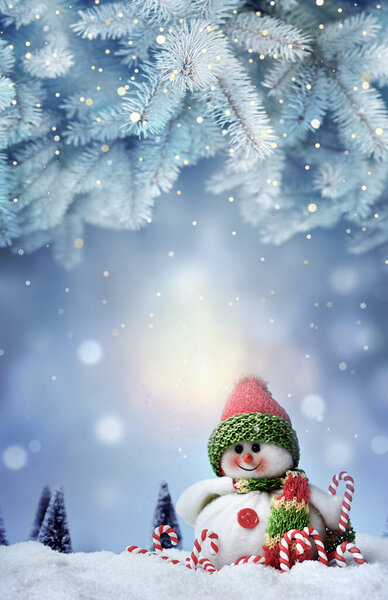 Snowman toy on the frozen winter background.