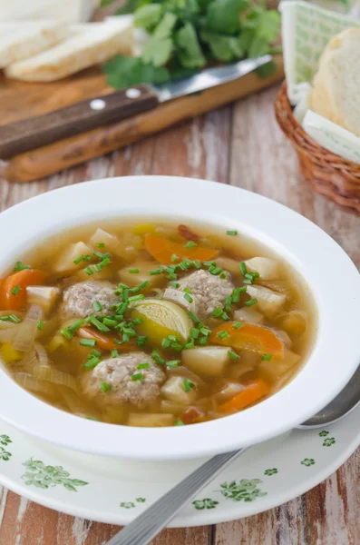 Plate of vegetable soup with meatballs on the wooden table — Stock Photo, Image