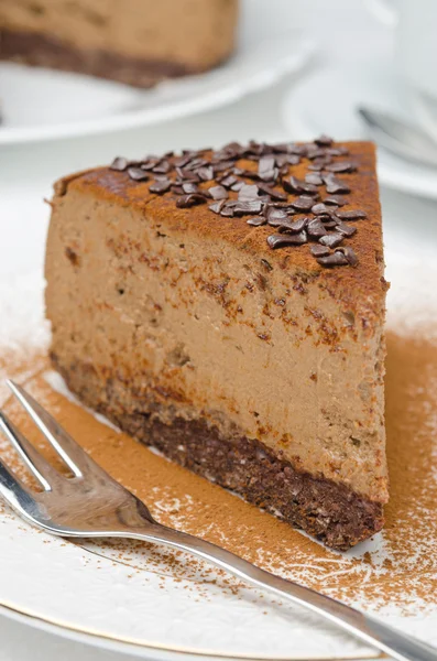 Piece of chocolate cheesecake on a plate closeup selective focus — Stock Photo, Image