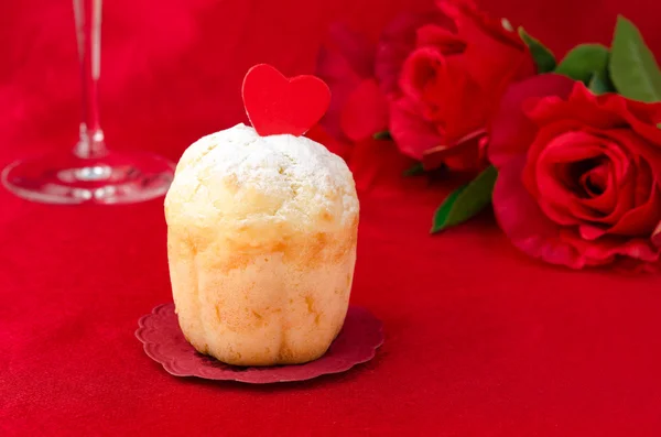 Rum Baba decorated with hearts on a red background — Stock Photo, Image