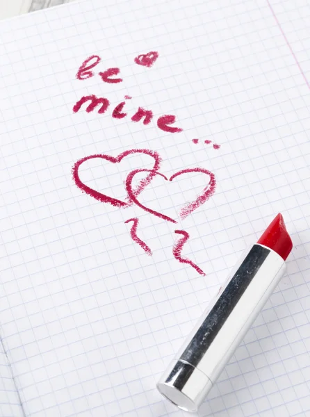 Sign on heart in a notebook and lipstick — Stock Photo, Image