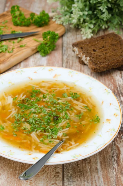 Chicken soup with noodles and carrots vertical — Stock Photo, Image