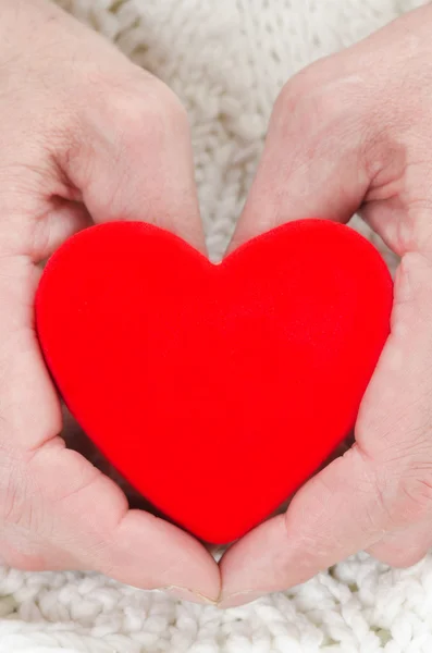 Red heart in the hands of men closeup — Stock Photo, Image