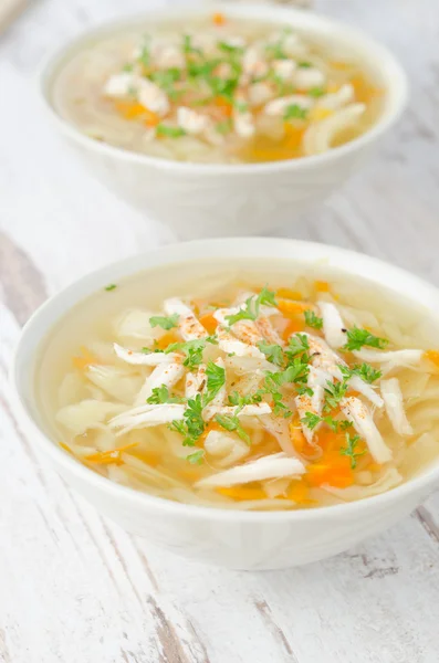 Two bowls of vegetable soup with chicken and parsley — Stock Photo, Image