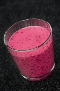 Blueberry smoothie on a black background