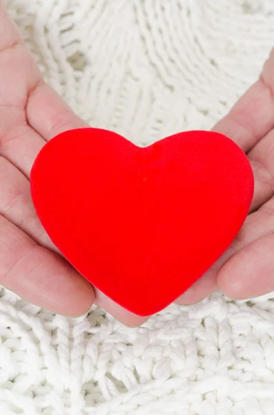 Red heart in the hands of men — Stock Photo, Image