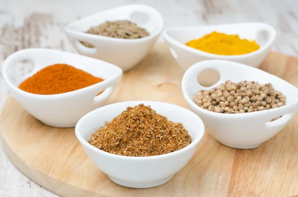 Collection of spices in white bowls on the wooden board (coriand Royalty Free Stock Photos