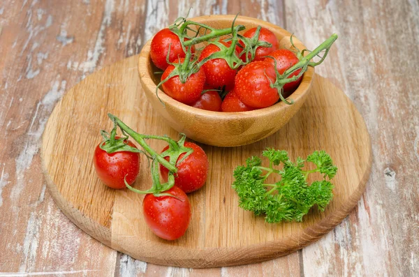 Cherry tomatoes in wooden bowl — Stock Photo, Image