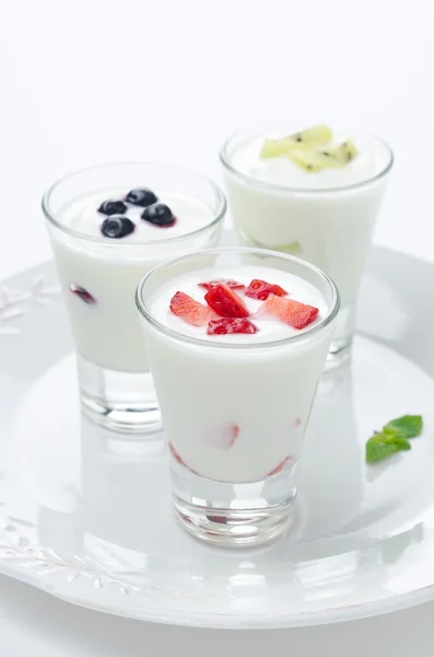 Three yogurt with fruit in a glass beaker vertical closeup — Stock Photo, Image