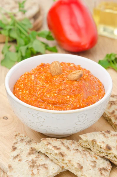 Roasted pepper dip with almonds and garlic in a bowl vertical — Stock Photo, Image
