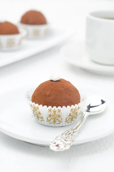 Small chocolate cake on a plate and a cup of coffee vertical — Stock Photo, Image