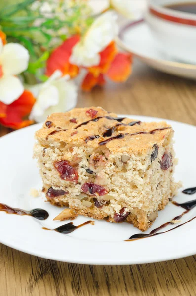 Piece of cake with dried cranberries and walnuts — Stock Photo, Image