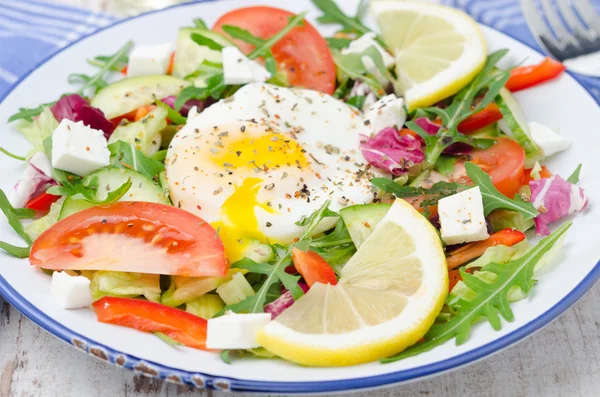 stock image Vegetable salad with poached egg on a plate, closeup