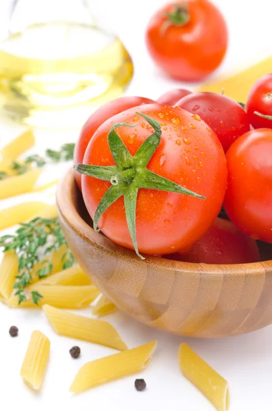 Fresh tomatoes, pasta penne, olive oil and spices closeup — Stock Photo, Image