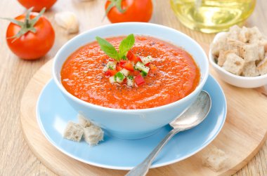 cold tomato soup gazpacho with basil and croutons in a bowl clipart