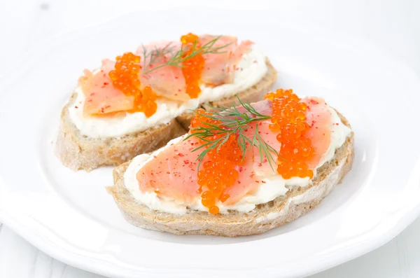 Sanduíche com creme de queijo, salmão salgado e caviar vermelho — Fotografia de Stock