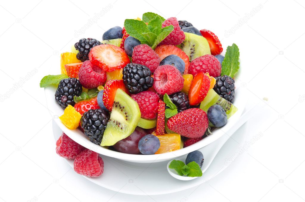 Salad of fresh fruit and berries in a bowl isolated on white