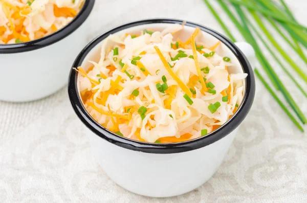 Salad of pickled cabbage with carrots and green onions close-up — Stock Photo, Image