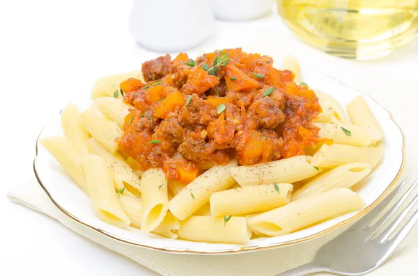 Penne pasta with sauce of beef, tomato and pumpkin on a plate — Stock Photo, Image