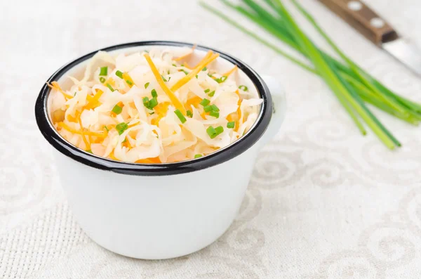 Salad of pickled cabbage with carrots and green onions in a cup — Stock Photo, Image