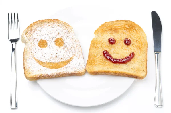 Toast with a smile of powdered sugar and jam on a plate — Stock Photo, Image