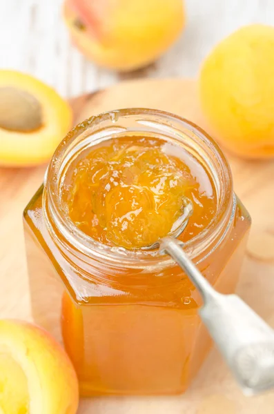 Apricot confiture in a spoon close-up, vertical — Stock Photo, Image