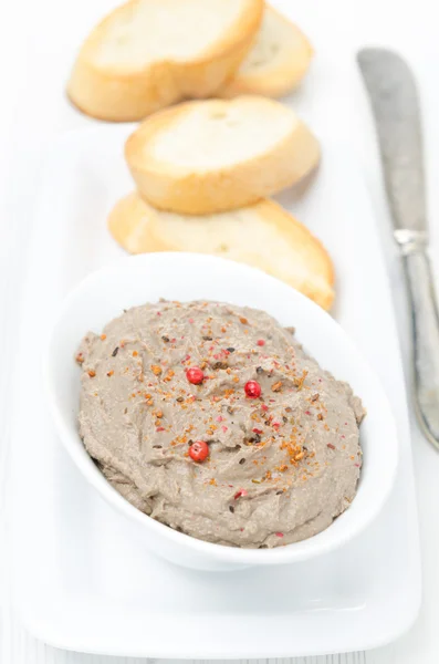 Liver pate with pink pepper in a white bowl, top view — Stock Photo, Image