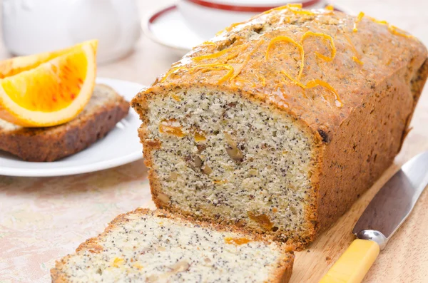 Orange cake with poppy seeds, dried apricots, walnuts and honey — Stock Photo, Image