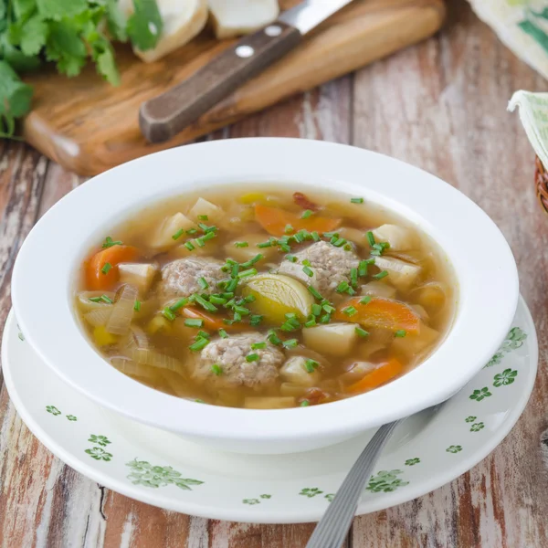 Plate of vegetable soup with meatballs on the wooden table — Stock Photo, Image