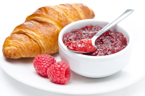 Fresh breakfast - raspberry jam and croissant on a plate — Stock Photo, Image