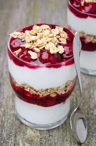 Postre en capas con yogur, granola y cereza, primer plano —  Fotos de Stock