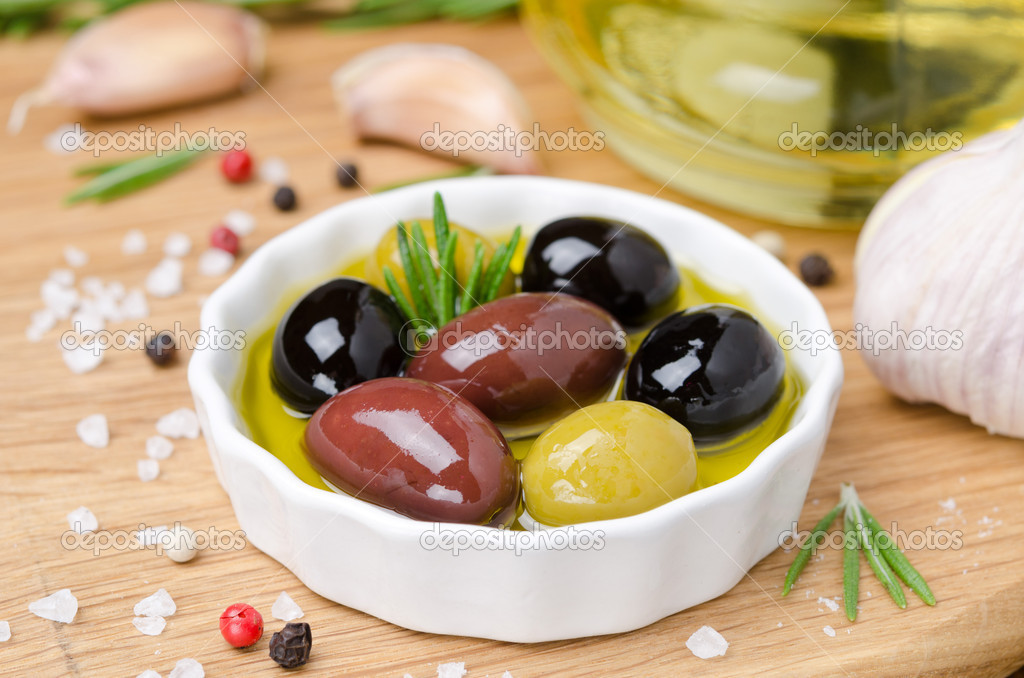 Bowl with different olives in olive oil and spices