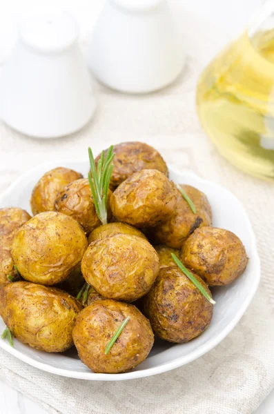 Batatas novas assadas com especiarias e alecrim em uma tigela — Fotografia de Stock