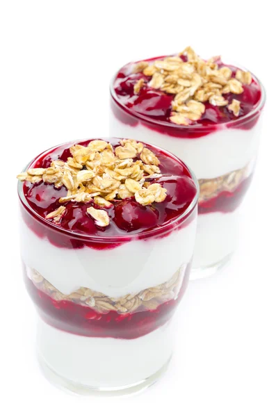 Layered dessert made of yogurt, granola and cherry on white — Stock Photo, Image