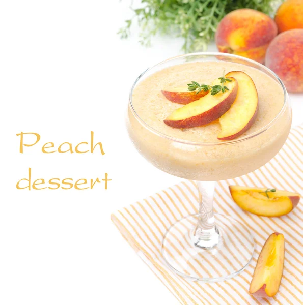Peach souffle in glass and fruit in the background, isolated — Stock Photo, Image