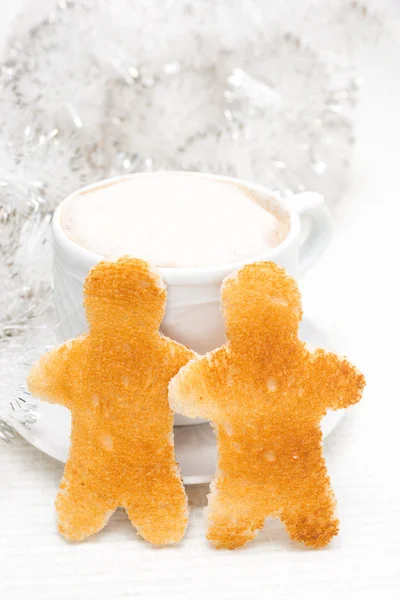 Toasted bread in the form of little men, cup of coffee — Stock Photo, Image
