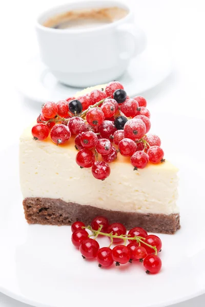 Piece of cheesecake with red and black currants on a plate — Stock Photo, Image