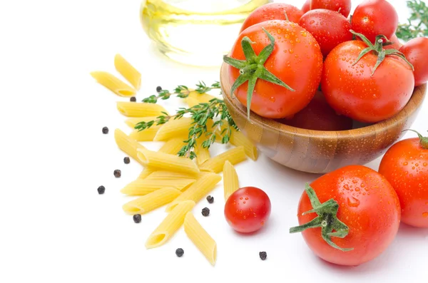 Fresh tomatoes, penne pasta, spaghetti and spices on white — Stock Photo, Image