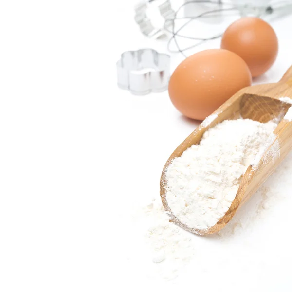 Scoop with flour, eggs and cookie cutters isolated — Stock Photo, Image